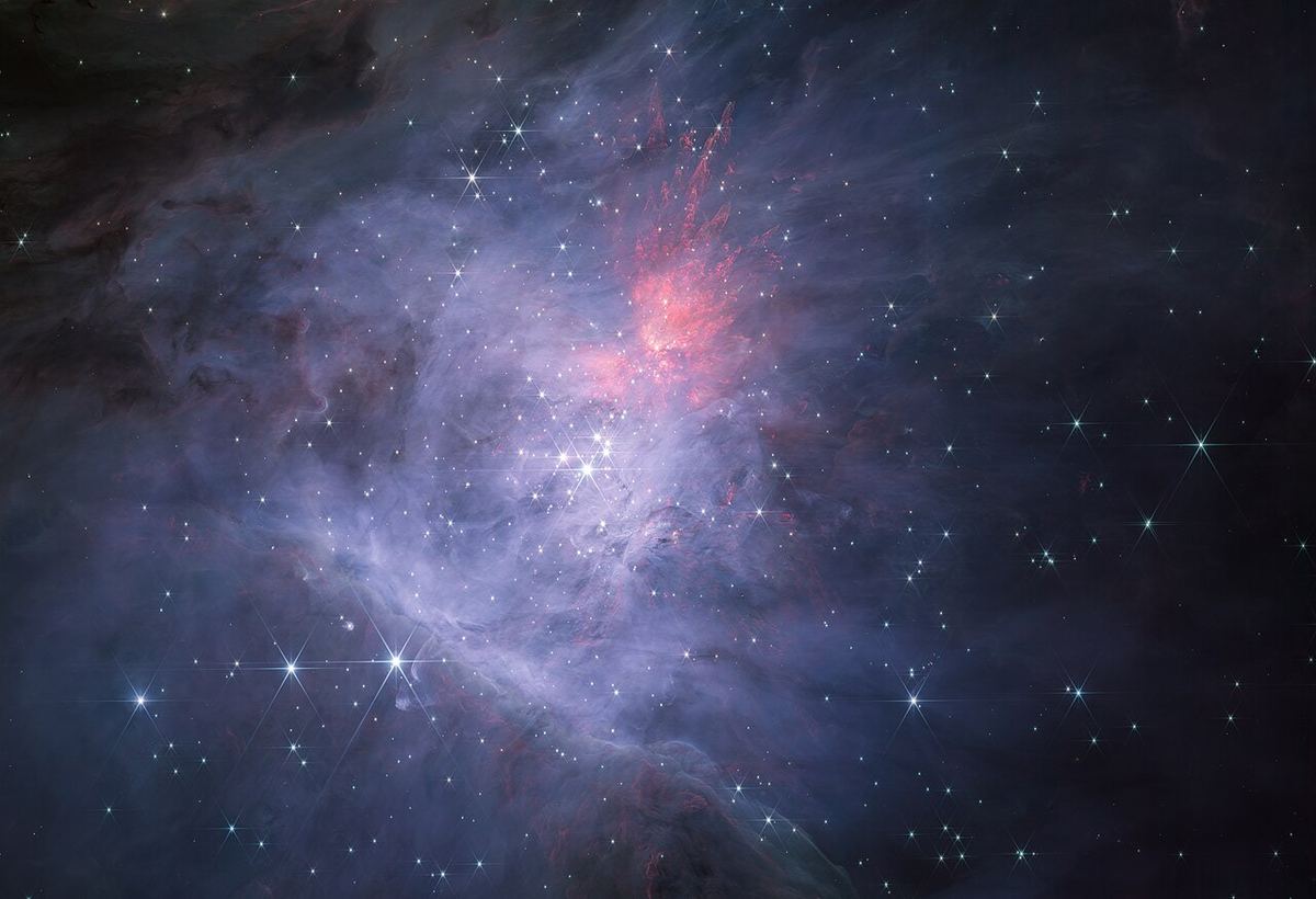 Miniatura: Nebulosa de Orionte em infravermelho próximo com nuvens de gás e estrelas jovens